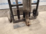 a machine that is sitting on the ground next to a wall
