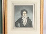 two framed pictures of a man in a black coat and a woman in a white dress