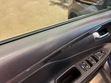 a close up of a car door handle with a hole in it