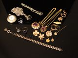 a lot of jewelry on a black table