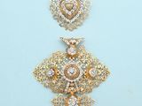 pair of gold and diamond earrings on a blue background