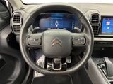the interior of a car with a steering wheel and dashboard controls