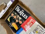 a cardboard box with a bunch of beatles books in it