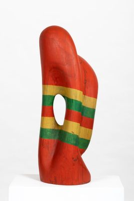 sculpture of a red, green, and yellow sculpture on a white pedestal