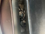 a metal door with wires in it on the inside of a vehicle