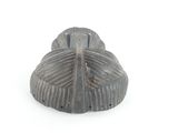 a close up of a metal object on a white surface