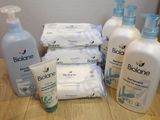 many bottles of lotion sitting on a table next to a bottle of lotion