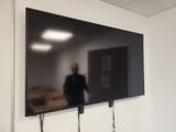 a man standing in front of a flat screen tv