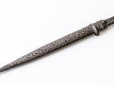 a close up of a knife on a white surface with a white background