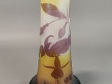 a glass vase with a design on it on a stand