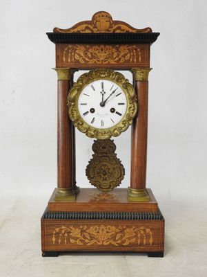 a wooden clock that is sitting on a table