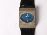 a watch that is sitting on a white surface