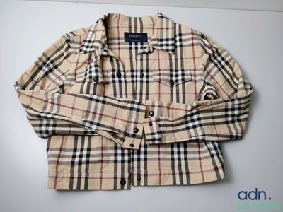 a close up of a plaid shirt on a white surface