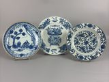 four blue and white plates with flowers and birds on them