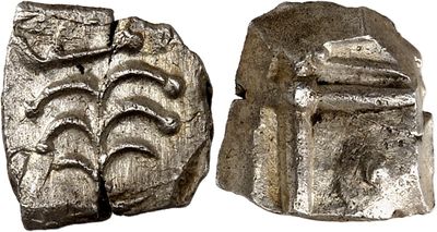 an image of a silver coin with a face on it