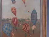 painting of a group of hot air balloons flying in the sky