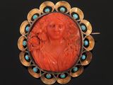 an antique carved coral and turquoise broochee broochle