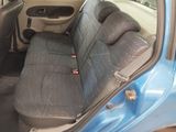 a blue car that has a seat cover on it