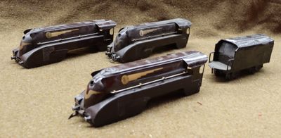 three toy trains that are sitting on a table