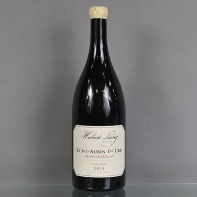 a bottle of wine sitting on top of a glass table