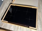 a stove top with a glass top on a wooden table