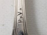 a silver spoon with a star on it sitting on a table