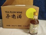 a bottle of tea sitting next to a cardboard box