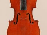 an old violin with a bow hanging from it ' s back