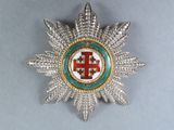 an image of a silver and gold broochle with a cross on it