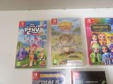 three nintendo wii games on a white table
