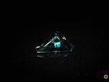 a close up of a triangular shaped glass object on a black surface