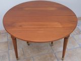 a small table with a wooden top on a tile floor