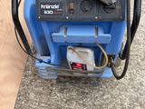 a blue machine that is sitting on the ground