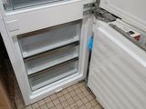 a white refrigerator with its door open in a room