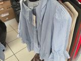 a lot of shirts hanging on a rack in a store