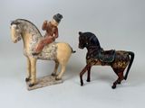 two figurines of a man on a horse and a man on a horse
