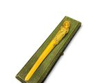 a yellow pen sitting on top of a green box