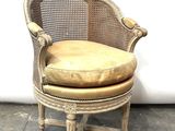 a chair with a cushion on top of it in front of a white wall