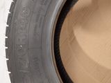 a close up of a tire on a wall with a hole in it
