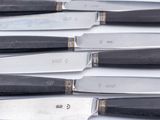 a lot of knives that are sitting on a table