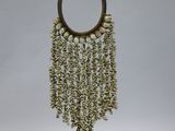 an image of a necklace made out of shells on a stand