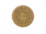 a close up of a gold coin on a white surface