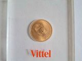 an image of a gold coin in a clear box with the word vittel on it
