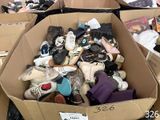 a cardboard box filled with shoes and other items