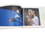 an open book with a picture of a tennis player on it