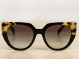 a close up of a pair of sunglasses sitting on a table