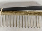 a close up of a hair comb on a white surface