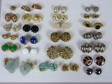 many different types of earrings on a white surface
