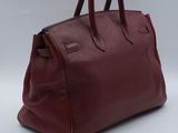 an image of a red leather handbag on a white background