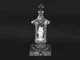 a black and white photo of a glass bottle on a stand